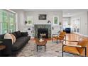 Cozy living room showcasing a fireplace, stylish furniture, and a large window view at 2485 S Fillmore St, Denver, CO 80210