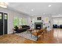 Bright living room featuring a modern fireplace, built-in shelves, and large windows overlooking the outdoors at 2485 S Fillmore St, Denver, CO 80210
