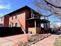 Rear and street side view of the house, showing the architectural details and outdoor space at 114 E 2Nd Ave, Denver, CO 80203