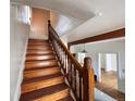 Classic wooden staircase with decorative banisters, providing access to the upper levels of the home at 114 E 2Nd Ave, Denver, CO 80203