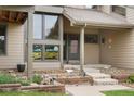 Inviting front entrance with decorative stained glass windows and a well-maintained landscape at 5812 Irish Pat Murphy Dr, Parker, CO 80134