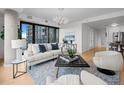 Modern living room with large windows offering city views, comfortable seating, and stylish decor at 1750 Wewatta St # 1501, Denver, CO 80202
