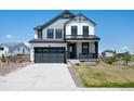 Charming two-story home with modern gray and white color scheme and attached two-car garage at 1041 W Witherspoon Dr, Elizabeth, CO 80107