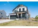 Charming two-story home with modern gray and white color scheme and attached two-car garage at 1041 W Witherspoon Dr, Elizabeth, CO 80107