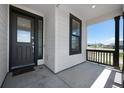 View of front porch with black railings, a storm door and a window with black trim at 1041 W Witherspoon Dr, Elizabeth, CO 80107