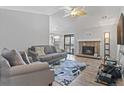 Bright living room with fireplace, gray sofas, and sliding door at 10970 W Florida Ave # 225, Lakewood, CO 80232