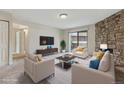 Staged living room with modern furniture, a stone fireplace, and sliding glass doors at 331 Wright St # 108, Lakewood, CO 80228