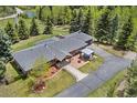 Stunning aerial view of the property highlighting the home's layout, landscaping, and surrounding greenery at 27436 Kennedy Gulch Rd, Conifer, CO 80433