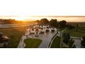 Expansive aerial view of the two-story home, highlighting the surrounding acreage and white fencing at sunset at 2495 Red Hawk Pl, Broomfield, CO 80023