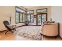 Bright living room featuring a cozy seating area, natural hardwood flooring, and an abundance of natural light at 6663 S Prescott Way, Littleton, CO 80120