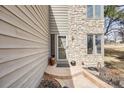 Close up of front porch showcasing stone accents, manicured landscaping, and inviting entry at 1579 W Briarwood Ave, Littleton, CO 80120
