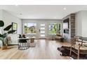 Stylish living room with hardwood floors, large windows, and modern fireplace at 3908 Mariposa St, Denver, CO 80211
