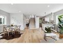 Bright open-concept living space features hardwood floors, dining area, and modern staircase at 3908 Mariposa St, Denver, CO 80211