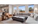 Inviting living room with large windows, comfortable seating, and modern decor at 12283 W 57Th Ln, Arvada, CO 80002