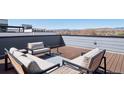 Cozy rooftop deck with comfortable seating and panoramic mountain views at 12283 W 57Th Ln, Arvada, CO 80002