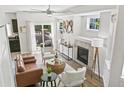 Bright living room featuring a fireplace, stylish decor, and sliding door access to a balcony at 12860 Jasmine St # C, Thornton, CO 80602