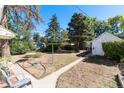 Expansive backyard featuring a shed, mature trees, and plenty of space for outdoor activities at 4110 Yates St, Denver, CO 80212