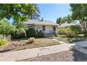 Quaint single-story home featuring a cozy front porch and mature trees in the yard at 4110 Yates St, Denver, CO 80212