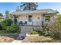 Inviting home with a covered front porch, perfect for enjoying the outdoors and curb appeal at 4110 Yates St, Denver, CO 80212