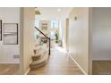 Inviting entryway featuring hardwood floors, a staircase, and views into the living room at 11680 Crow Hill Dr, Parker, CO 80134