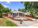 Charming home with a well-maintained lawn, mature trees and stylish gravel landscaping at 951 S Osage St, Denver, CO 80223