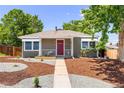 Charming one-story home with a red front door, awnings, and creative gravel landscaping at 951 S Osage St, Denver, CO 80223