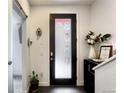 Inviting entryway featuring a frosted glass door, dark tile flooring, decorative sconces, and tasteful decor accents at 3030 Wilson Ct # 5, Denver, CO 80205