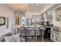 Bright kitchen features bar seating at the island, stainless steel appliances, and an open floorplan at 3030 Wilson Ct # 5, Denver, CO 80205