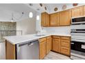 Well-lit kitchen boasts white countertops and stainless steel appliances at 9320 W Ontario Dr, Littleton, CO 80128