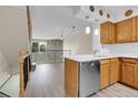 Modern kitchen features a stainless steel dishwasher and light wood cabinets at 9320 W Ontario Dr, Littleton, CO 80128