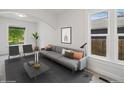 Bright living room featuring a modern sofa, neutral tones, and large windows for plenty of natural light at 3817 Osage St, Denver, CO 80211