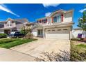 Charming two-story home featuring red shutters, a well-maintained lawn, and a spacious two car garage at 5570 Perth Ct, Denver, CO 80249