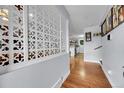 Bright entryway with decorative screen, hardwood floors and glimpses of the modern kitchen at 55 S Flower St, Lakewood, CO 80226
