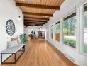 Inviting living room boasting wood floors, exposed beam ceiling, fireplace, and large windows offering ample natural light at 5471 S Sherman St, Littleton, CO 80121