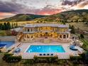 Expansive backyard featuring a sparkling pool, stone patio, and scenic mountain views, perfect for outdoor entertaining at 6729 Bear Point Trl, Golden, CO 80403