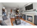 Cozy living room featuring a fireplace with granite surround, comfortable seating, and hardwood floors at 9019 E Panorama Cir # D416, Englewood, CO 80112