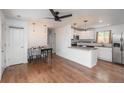 Bright open-concept kitchen and dining area with hardwood floors and granite countertops at 3629 W Custer Pl, Denver, CO 80219