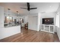 Bright open-concept living space with hardwood floors and a modern ceiling fan at 3629 W Custer Pl, Denver, CO 80219