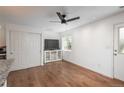 Bright open-concept living space with hardwood floors, modern ceiling fan, and a closet at 3629 W Custer Pl, Denver, CO 80219