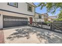 Charming two-story home showcasing a driveway and inviting front entrance with a well-manicured lawn at 1676 S Fairplay St, Aurora, CO 80012