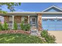 Inviting front entrance with brick accents and a blue garage door at 433 N 15Th Ave, Brighton, CO 80601