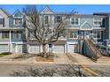 Exterior view of a townhome with a 1 car garage and stairs to the front door at 1699 S Trenton St # 147, Denver, CO 80231
