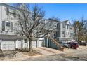 View of townhomes with attached garages and well-maintained landscaping at 1699 S Trenton St # 147, Denver, CO 80231