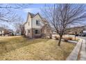 Attractive two-story home featuring stone accents and a well-maintained lawn at 1334 Carriage Dr, Longmont, CO 80501