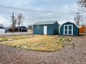 View of backyard and detached sheds with well-maintained grass at 4901 Bryant St, Denver, CO 80221