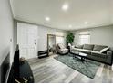 Bright living room featuring hardwood floors, a comfortable sofa, and natural light at 4901 Bryant St, Denver, CO 80221