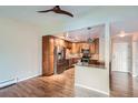 Modern kitchen featuring stainless steel appliances, wood cabinets, and granite countertops at 9655 E Center Ave # 11D, Denver, CO 80247