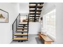 Bright entryway with modern staircase, wooden bench, and tiled floor at 108 Arapahoe St, Golden, CO 80403