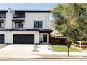 Contemporary white farmhouse with black trim, garage, and a well-manicured front yard at 108 Arapahoe St, Golden, CO 80403
