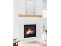 Modern fireplace with marble surround, wooden mantel, and contrasting white shiplap at 108 Arapahoe St, Golden, CO 80403